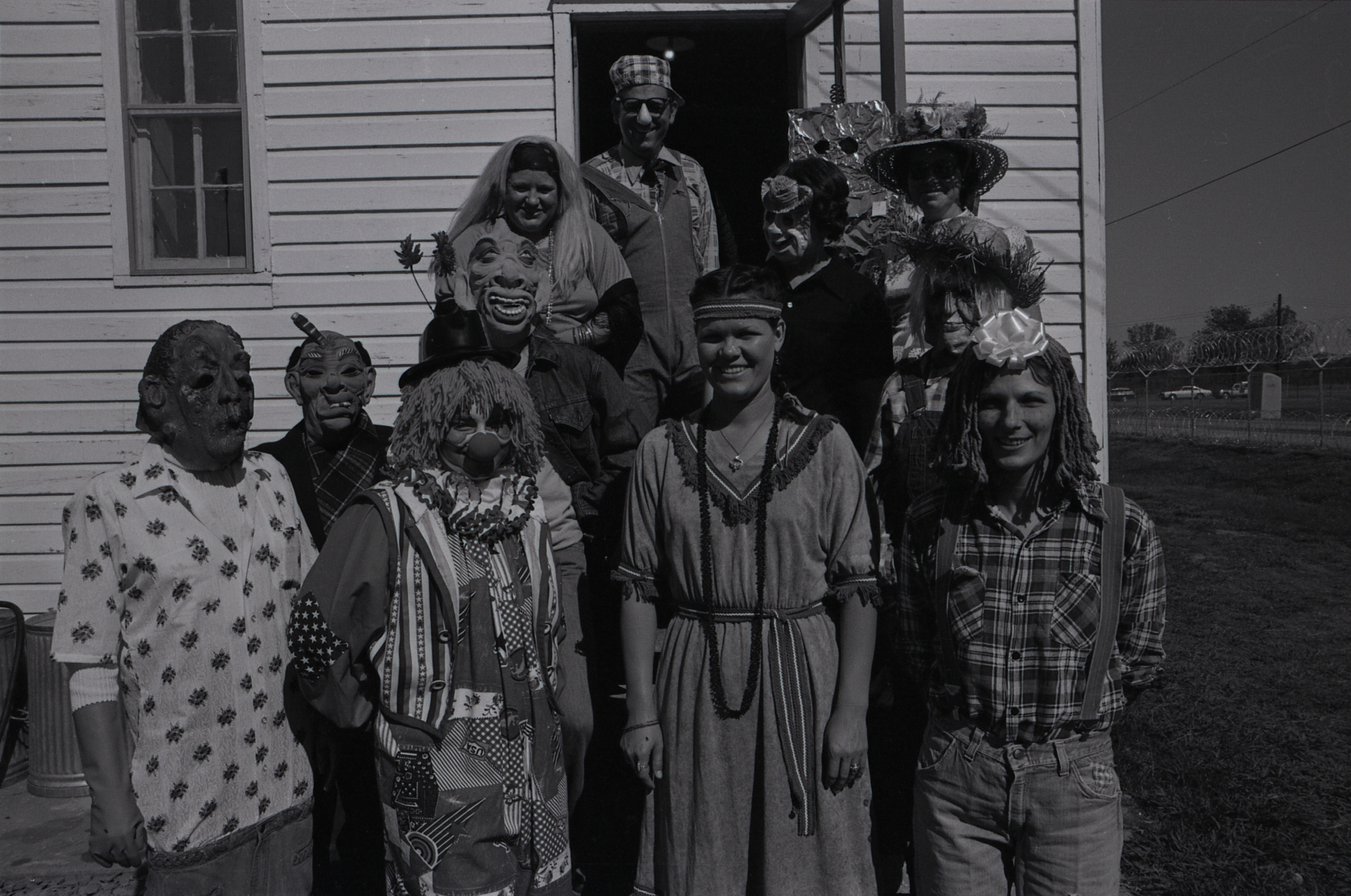 A black and white photograph of a group dressed up in Halloween costumes.