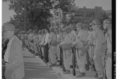 Soldiers lined up along curb in front of Central High School