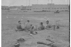 Four soldiers watching soccer match