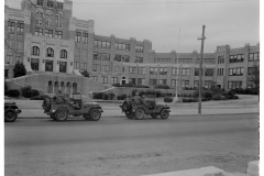 Soldiers in jeeps parked in front of Central High School