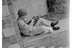 Arkansas National Guardsman seated with rifle