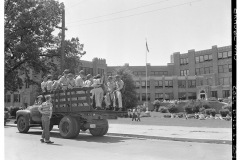 Boy talking to Arkansas National Guard troops on back of truck