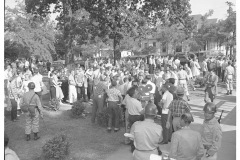 Students, soldiers, and newsmen mingle in front of Central High School