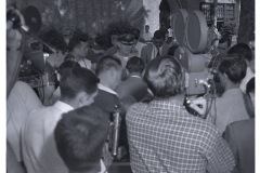 Unidentified group of students surrounding microphone and (presumably) a reporter.