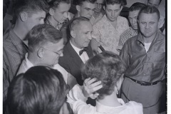 Unidentified group of students surrounding microphone and (presumably) a reporter.