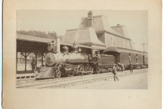 Train at railroad station with passengers and workers onboard, Hot Springs