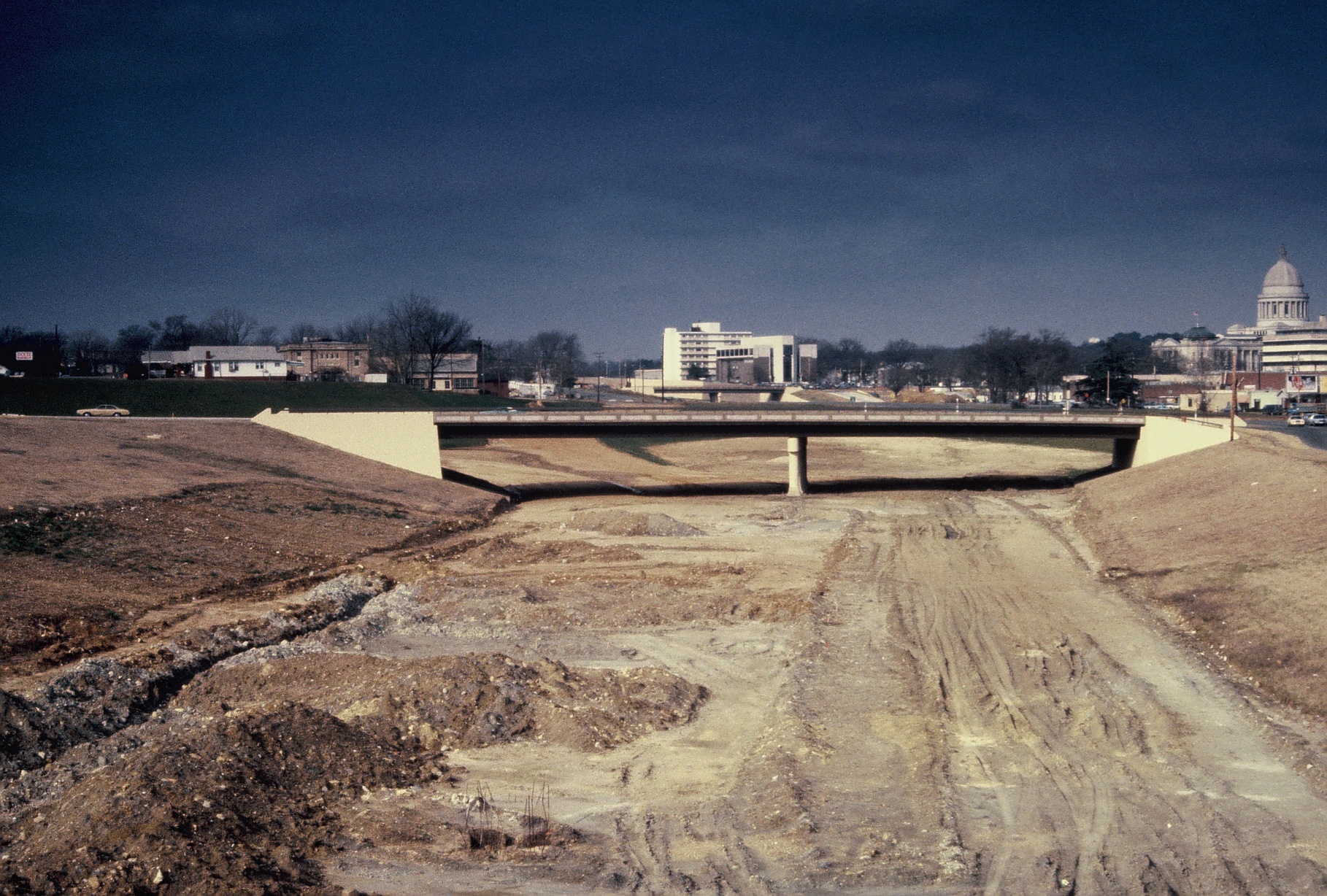 Photograph of Interstate 630 construction looking west with the Chester Street Bridge and the Arkansas State Capitol building on the right. City of Little Rock Planning & Development records