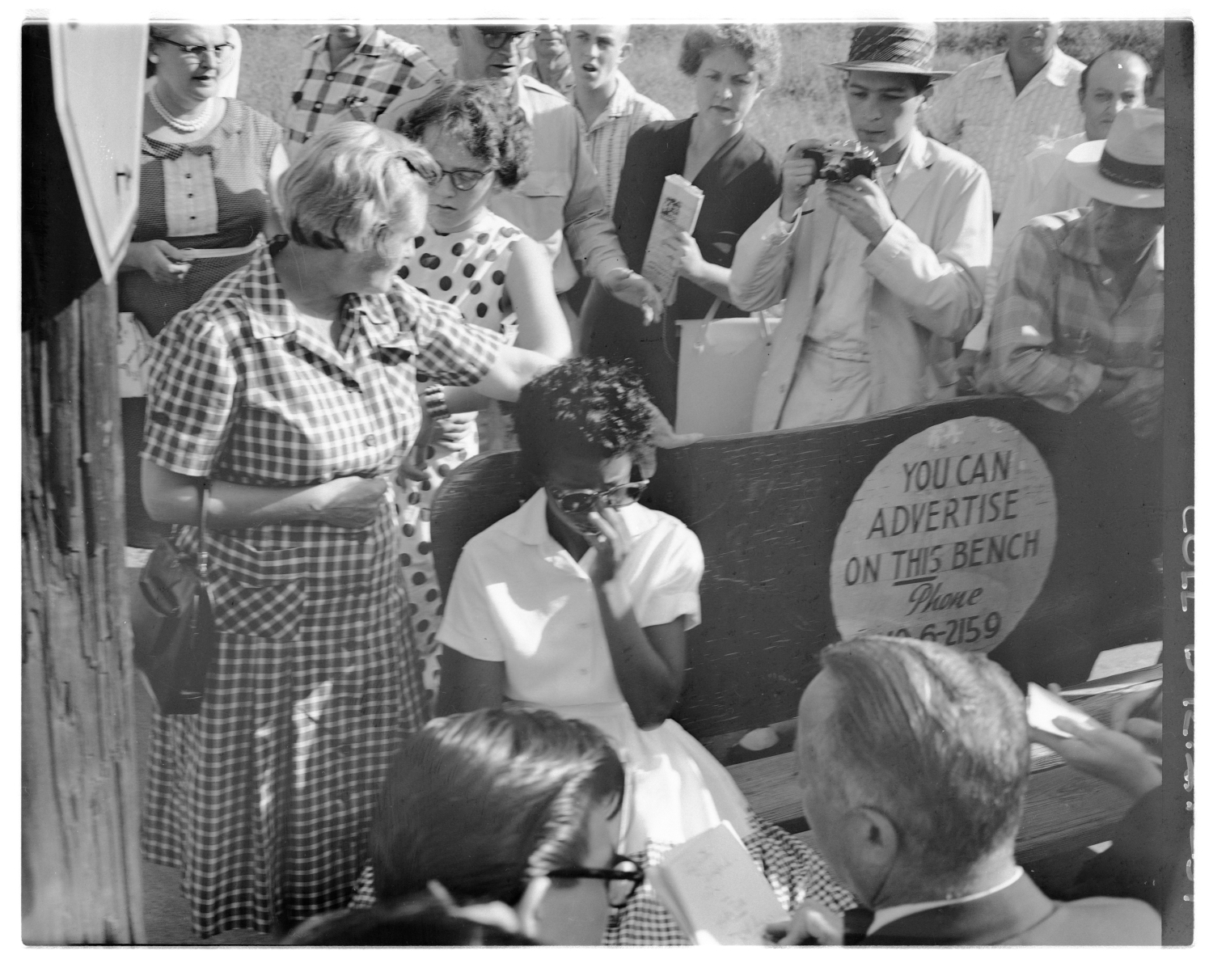 Elizabeth Eckford with Grace Lorch by bus bench surrounded by protesters, 1957 September 4 Elizabeth Eckford with Grace Lorch by bus bench surrounded by protesters, 1957 September 4