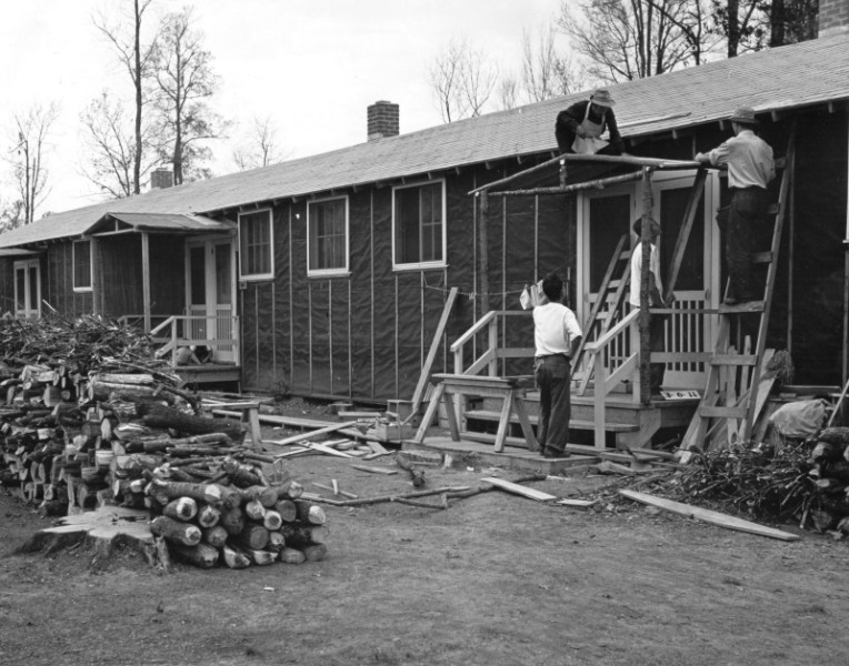 Three men build a porch cover for a barracks doorway at Rohwer Relocation Center (from the Life Interrupted Collection.