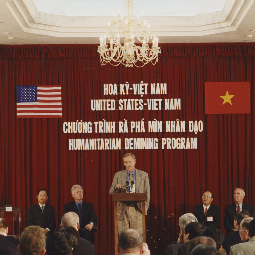 Color photograph of Snyder giving a speech during the trip to Vietnam