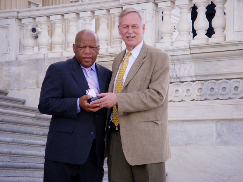 Reps. John Lewis and Vic Snyder holding the Central High School Desegregation Silver Dollar in front of the U.S. Capitol, 2007