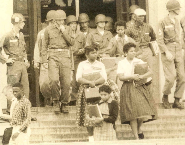 Several of the Little Rock Nine leave Central High School under troop escort, 1957