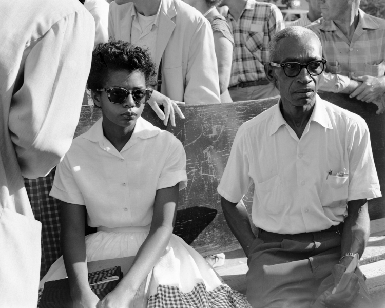 Elizabeth Eckford sitting on the bus bench outside of Central High School, 1957