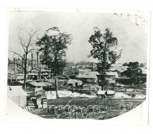 Steamboats anchored at Des Arc during Civil War with cargo and wagon parts lining the shore - 1863-1864 - Huddleston Steamboat Photograph Collection, ca. 1827-1976, UALR.PH.0070 - UA Little Rock Center for Arkansas History and Culture