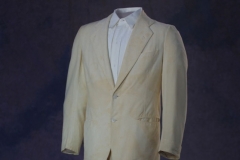 Image of Governor Charles Brough two piece suit in the "Palm Beach" style. The white jacket features two white buttons on the front and on the cuff. The suit is from the campus shop and made by Goodall and Sanford, Inc.