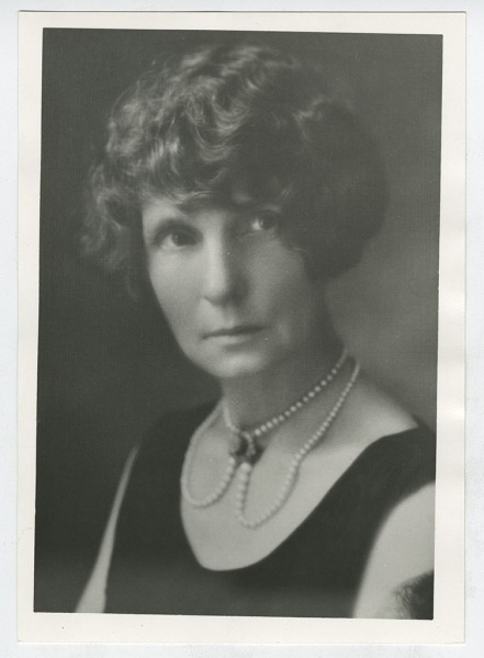 Bernie Babcock in black dress with pearls.