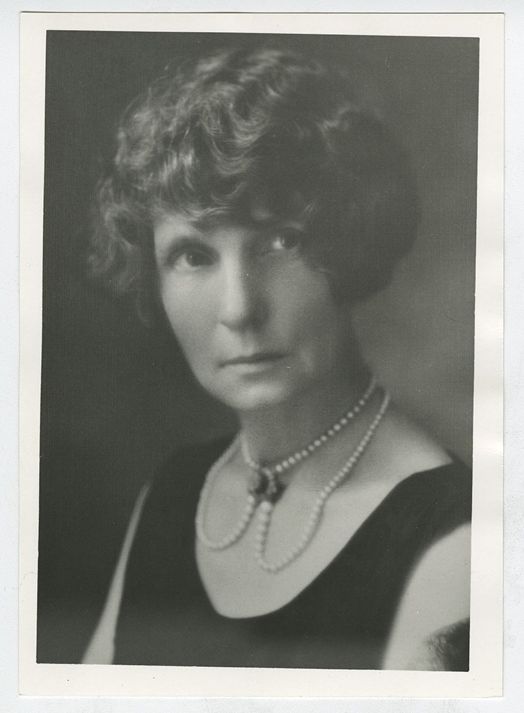 Bernie Babcock in black dress with pearls.