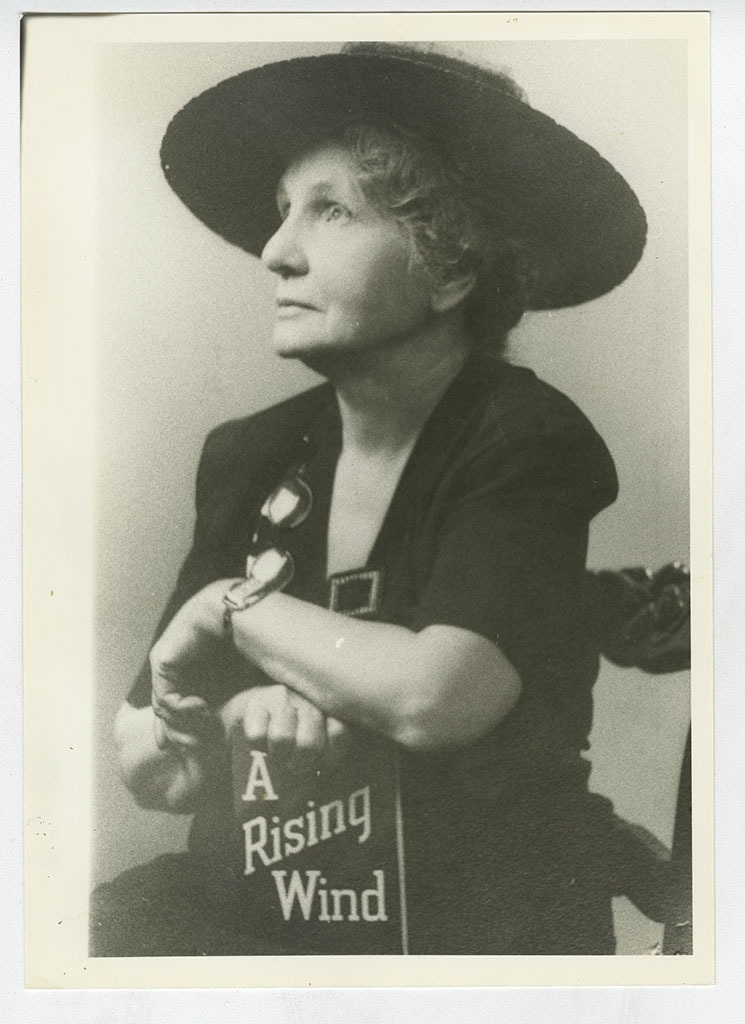 Bernie Babcock poses with her book, A Rising Wind.