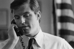 Jim Guy Tucker on telephone in office