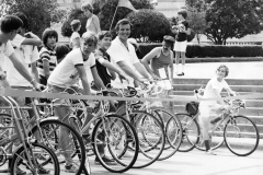 Jim Guy Tucker riding bicycle in race with crowd near Capitol building