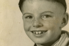 Jim Guy Tucker as child in cub scout uniform