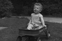 Toddler Jim Guy Tucker in wagon