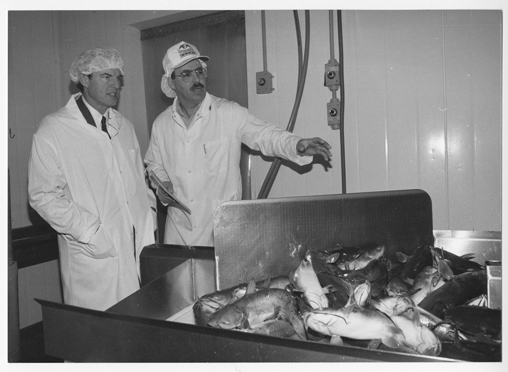 Jim Guy Tucker with man and catfish in Eudora, the Catfish Capital of Arkansas Jim Guy Tucker with man and catfish in Eudora, the Catfish Capital of Arkansas