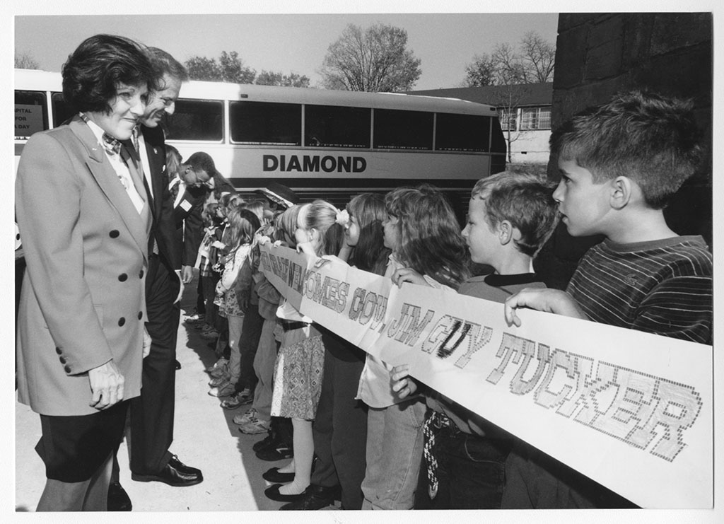 Jim Guy Tucker and Betty greeted by kids beside bus in Leslie, Arkansas Jim Guy Tucker and Betty greeted by kids beside bus in Leslie, Arkansas