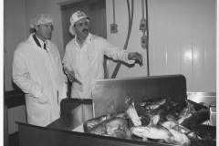 Jim Guy Tucker with man and catfish in Eudora, the Catfish Capital of Arkansas