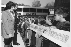 Jim Guy Tucker and Betty greeted by kids beside bus in Leslie, Arkansas
