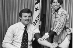 Jim Guy Tucker with nurse, supporting program for detecting high blood pressure