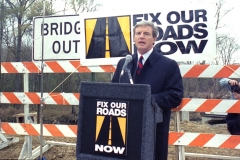 Jim Guy Tucker at outdoor event for 'Fix Our Roads Now' event