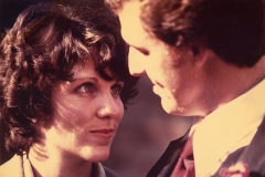 Jim Guy Tucker and Betty Tucker stand close, looking at each other, April 1976.