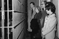 Jim Guy Tucker, as prosecuting attorney, with unidentified individuals, visiting jail, 1971