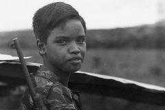 Boy soldier in a field, possibly Central Highlands village, Vietnam