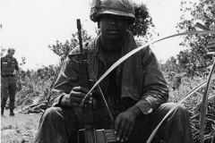 Birnes Penix sitting with gun, Vietnam