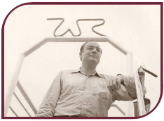 Sepia photograph of Winthrop Rockefeller standing in front of WR sign at Winrock