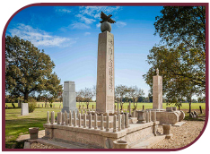 Color photograph of an obelisk and monument to the Rohwer dead