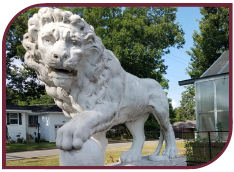 Color photograph of the marble lion statue on the WSB campus