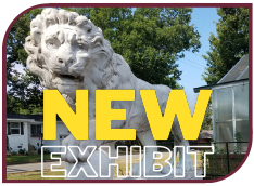 Color photograph of the marble lion statue on the WSB campus. Text on it reads, "New Exhibit"
