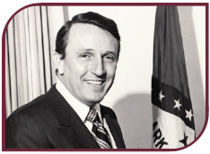 Black and white photograph of Dale Bumpers with the Arkansas flag