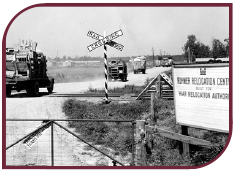 Black and white photograph of trucks arriving at Rohwer Relocation Center