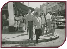 Black and white photograph of two blind men learning to use their white canes in downtown Little Rock