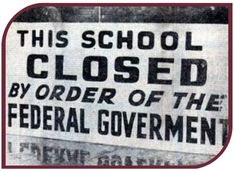 Black and white photograph of a sign that says, "This school closed by order of the federal government"