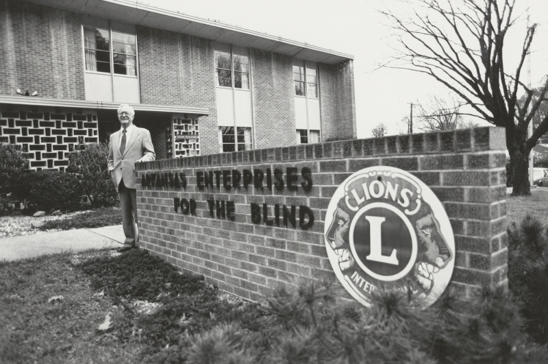 Roy Kumpe next to the Arkansas Enterprises for the Blind sign, circa 1960s