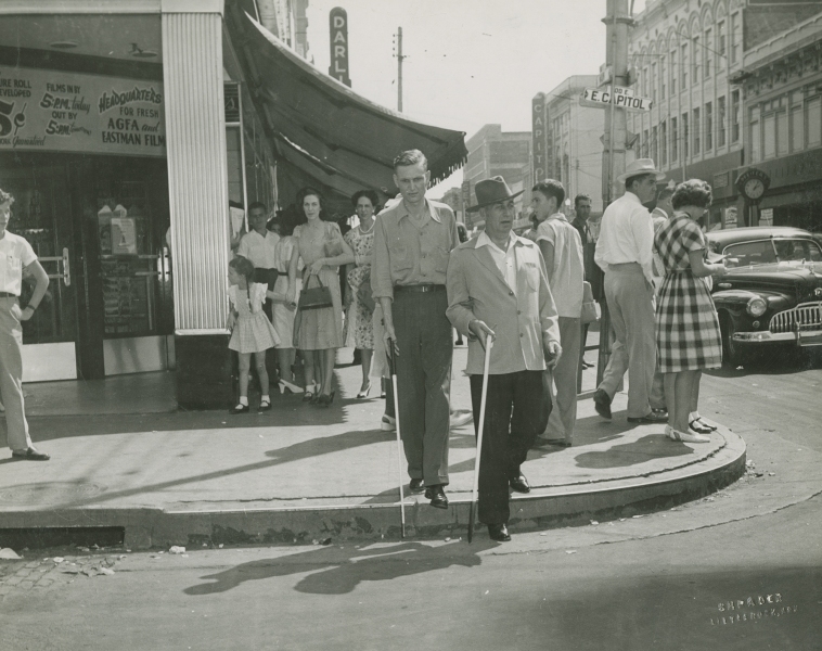 Trainees learning to use white canes in downtown Little Rock, circa 1950s