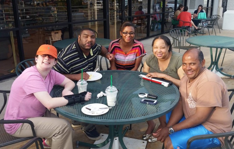 Five clients sitting at a table outside of Starbucks, 19 June 2015